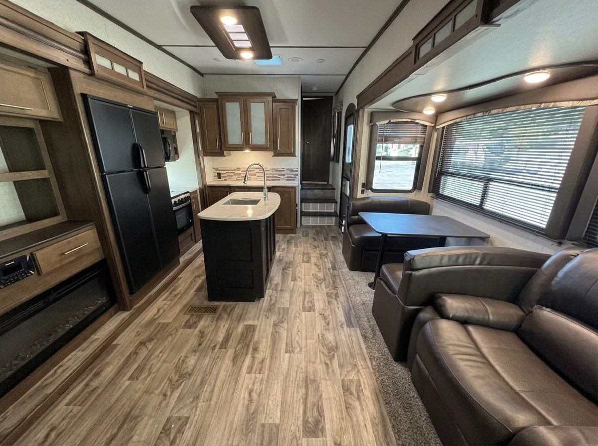Living area with reclining theater seats and a fireplace