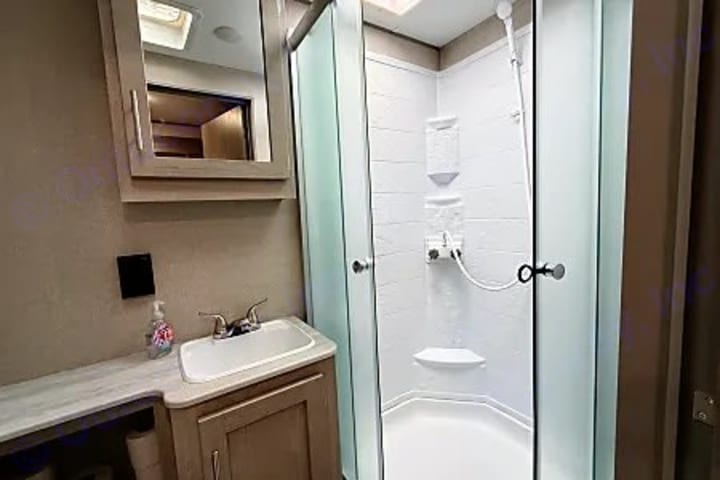 Camper bathroom with vanity and walk in shower
