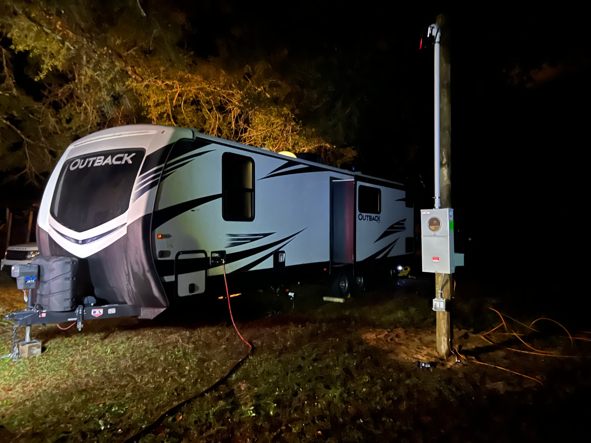 Temporary power pole and electrical service installed beside a customer's RV housing unit on their property during an insurance claim