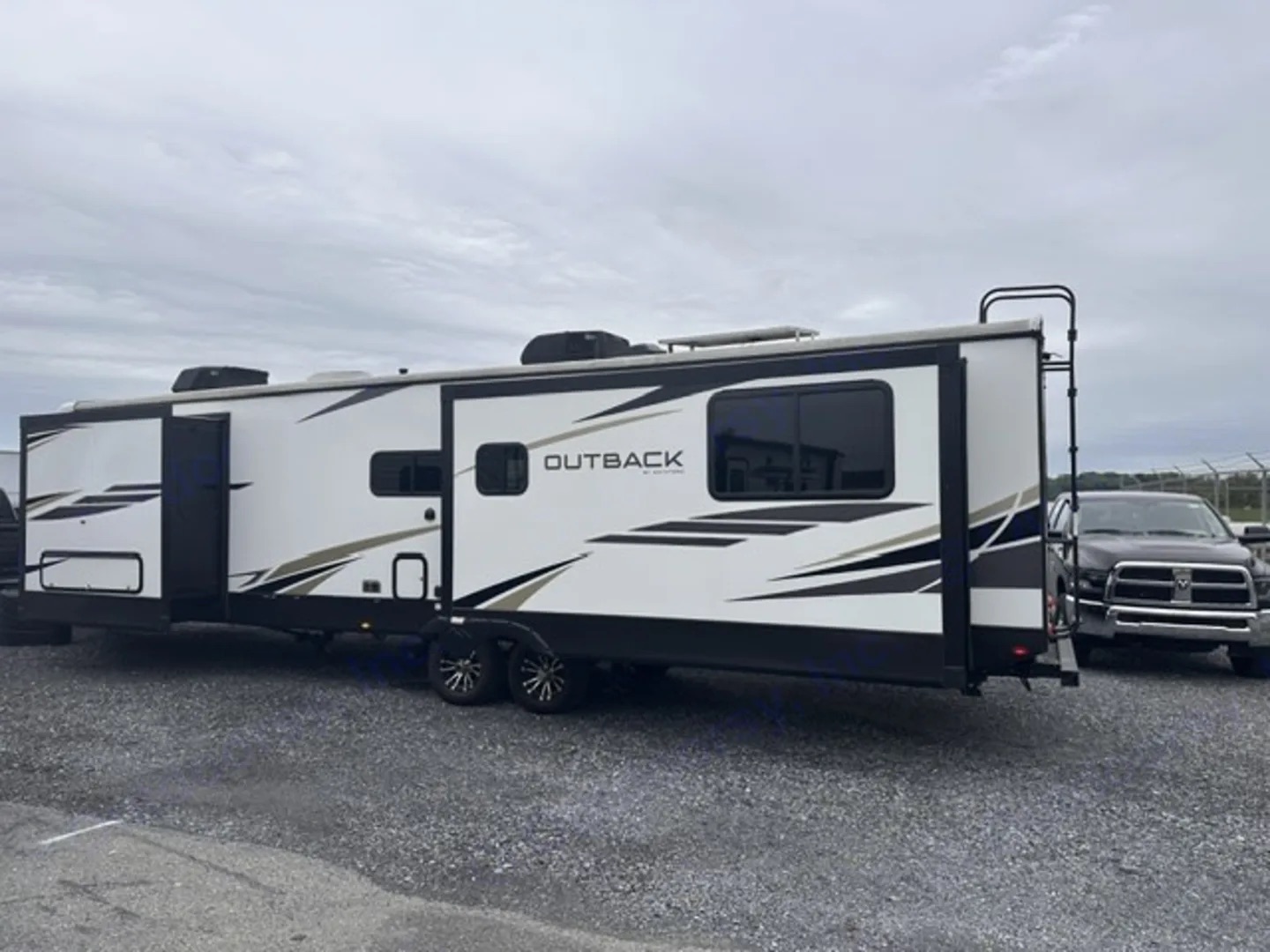 Door side of a Keystone Outback travel trailer with slide outs extended