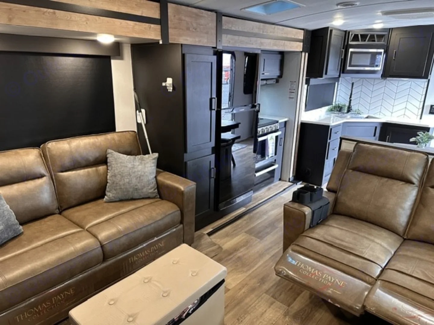 Camper living area with a sofa and reclining seating