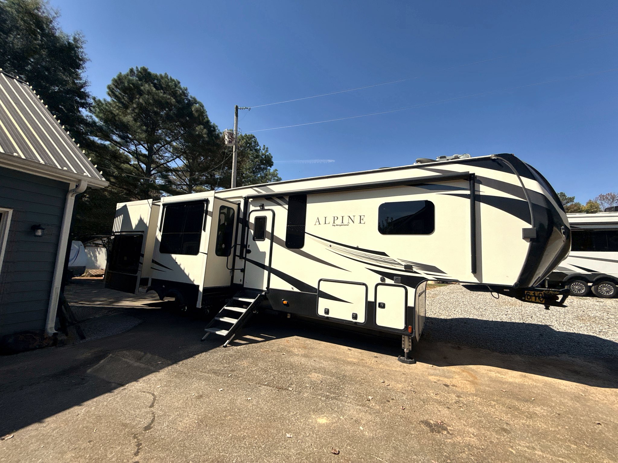 Exterior of a Keystone Alpine fifth wheel with the slide outs extended