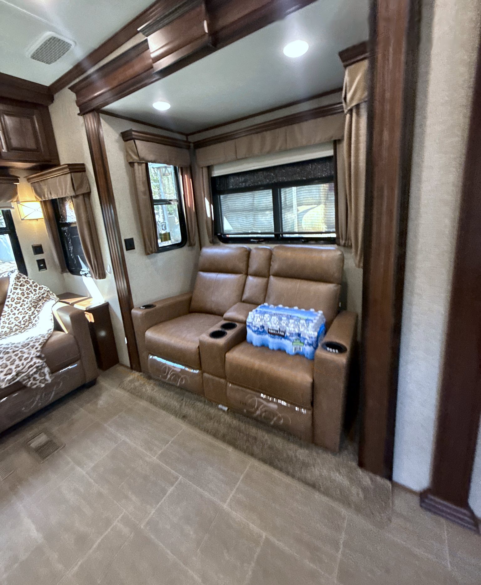 Camper theater seating with cup holders and a center console