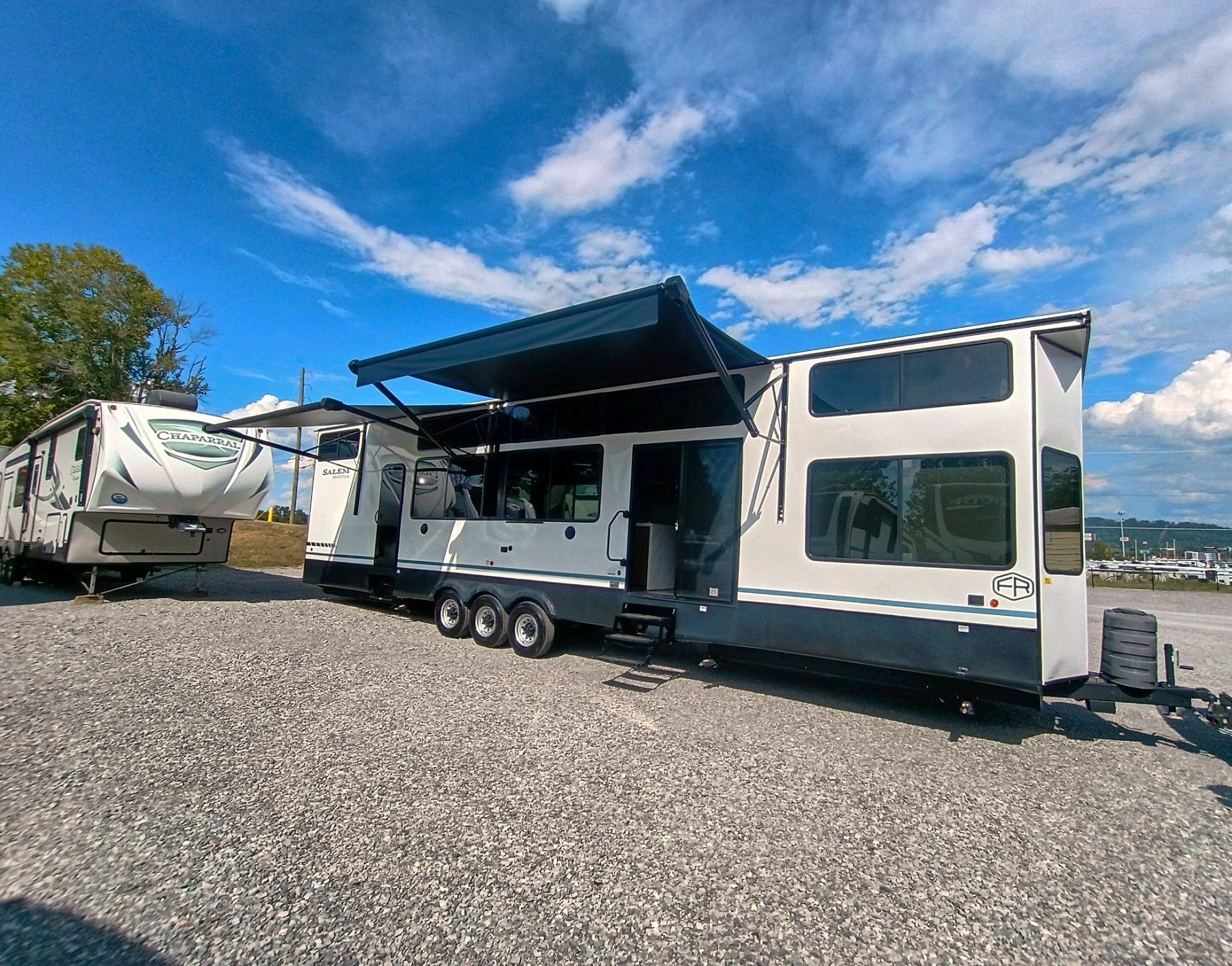 Exterior of a Forest River Salem Grand Villa destination trailer with the awnings extended